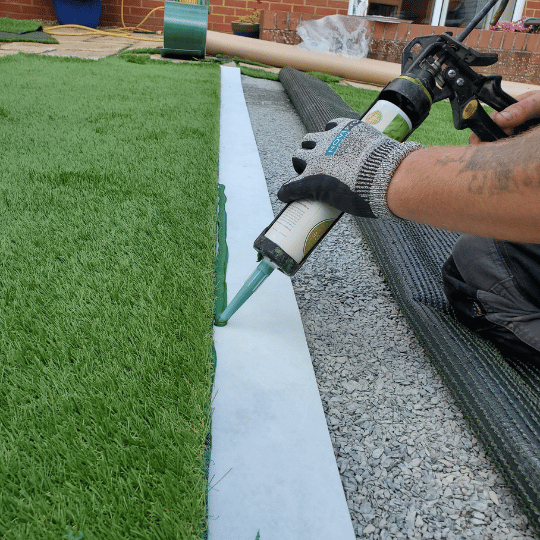 How to Install Artificial Grass. Artificial Grass fitter gluing the joining tape.